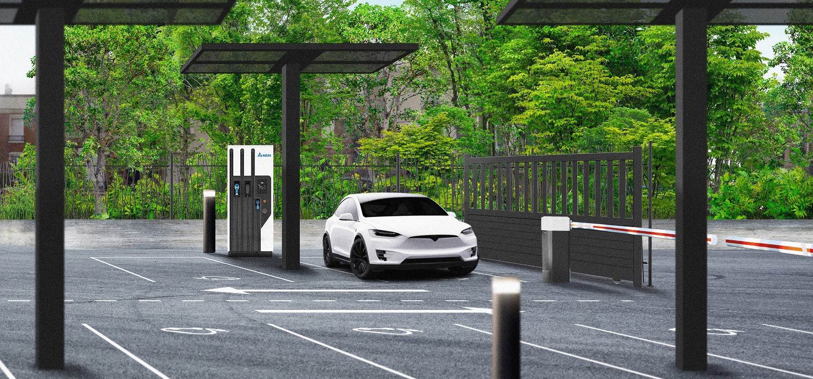 Une voiture électrique blanche est garée à une station de recharge pour VE dans un parking pratiquement vide, avec des panneaux solaires et des arbres verts en arrière-plan.
